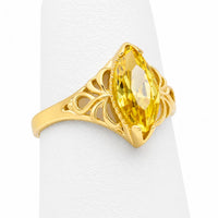 Anillo marquesa de oro para mujer con piedra de circonia amarilla, diseño calado y acabado brillante.